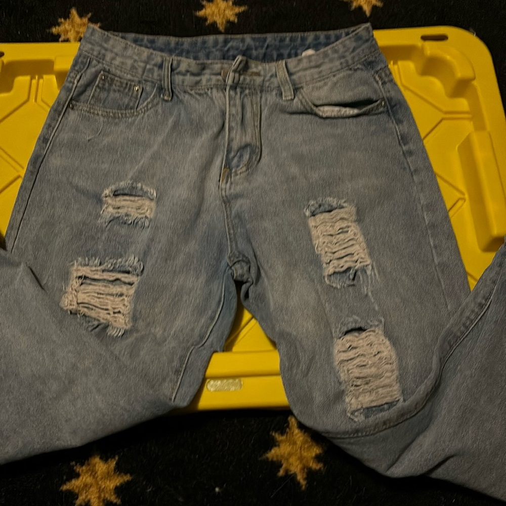 Denim blue jeans with holes